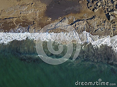 Aerial photograph of a rocky coastline with arriving and breaking ocean waves Stock Photo