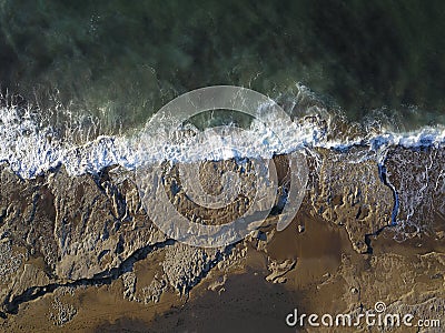 Aerial photograph of a rocky coastline with arriving and breaking ocean waves Stock Photo