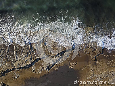 Aerial photograph of a rocky coastline with arriving and breaking ocean waves Stock Photo