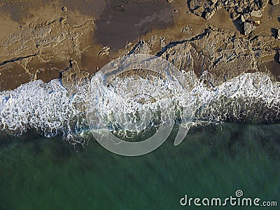 Aerial photograph of a rocky coastline with arriving and breaking ocean waves Stock Photo