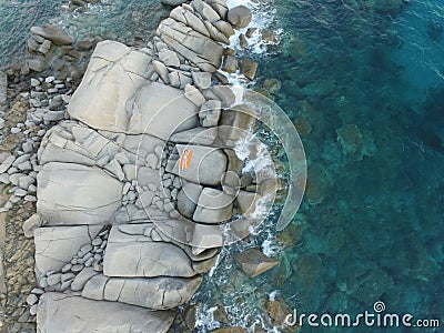 Aerial photography of the Sardinia coast during a summer sunset. Small waves on the rocks taken with a drone Stock Photo