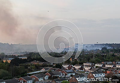 An aerial picture of a Heath land wildfire on the edge of an area of housing Stock Photo
