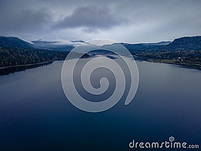 The drone picture of cloudy and foggy Lake Teletskoye in Altai mountains forests in Russia Stock Photo