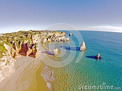 Aerial from rocks and ocean at Praia tres Irmaos in Algarve Port Stock Photo