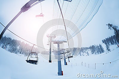 Aerial ropeway with empty chairlifts at foggy day Stock Photo