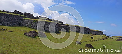 AERIAL: Scenic drone shot of old stone houses on picturesque Easter Island. Stock Photo