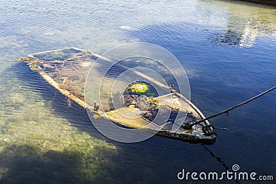Aerial shot of an abandoned old boat found in the sea Stock Photo