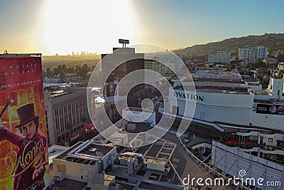 an aerial shot along Hollywood blvd at sunset with hotels, office buildings and shops in the city skyline, lush green trees Editorial Stock Photo