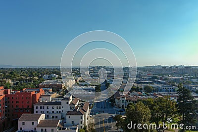 Aerial shot along Raymond Ave with lush green trees, grass and plants and red brick buildings with cars driving on the street Editorial Stock Photo