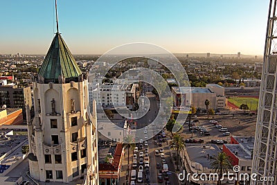 an aerial shot along Vine avenue at sunset with hotels, office buildings and shops in the city skyline, lush green trees Editorial Stock Photo