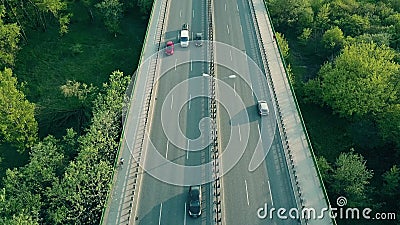 Aerial shot of cars, runner and cyclist moving along highway in the evening Stock Photo