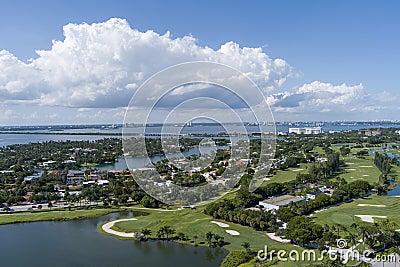 Aerial shot of a gorgeous summer landscape at Miami Beach Golf Club with lush green grass and trees, blue ocean water, homes Stock Photo