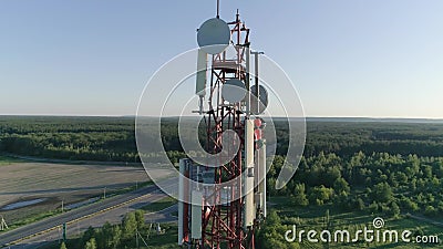 Aerial shot Maintenance personnel on cellular antenna at telecommunication tower stock footage Aerial shot Maintenance personnel on cellular antenna at telecommunication tower stock footage