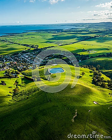 Aerial shot of a rural landscape featuring a lake and green fields. Toora, Victoria, Australia. Stock Photo