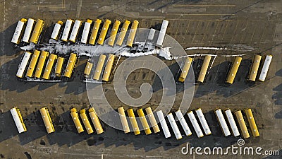 Aerial shot of school busses parked in a lot. Stock Photo