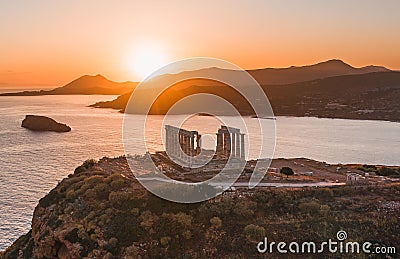 Aerial shot of the temple of Poseidon at a bright orange sunset in Athens, Greece Editorial Stock Photo