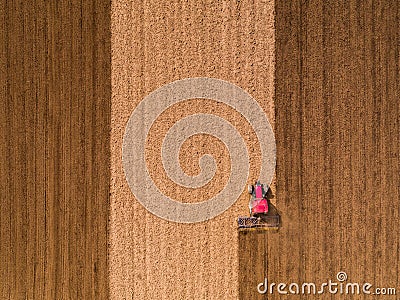 Aerial shot of a tractor cultivating field at spring Stock Photo