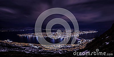 Aerial shot of a Tromso night sky with the cityscape under, Norway Stock Photo
