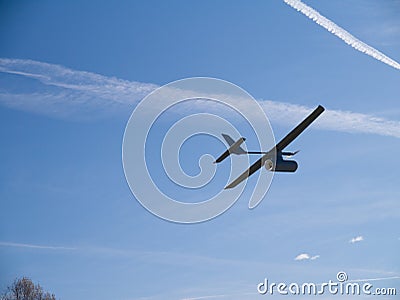 Drone airplane, low altitude passage, sunny sky with clouds Stock Photo
