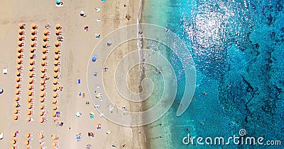 AERIAL. Summer beach with people and turquoise ocean water Stock Photo