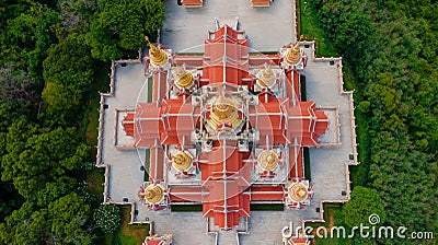 Aerial top angle drone view closeup above pagoda temple of Wat PraMahathadchedi Pakdeeprakad or Tang Sai temple on mountain forest Stock Photo