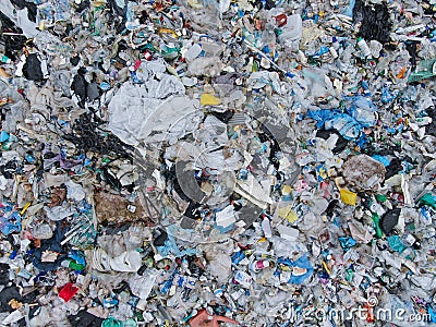 AERIAL: View from above of a stinky heap of garbage in a plastic sorting site Stock Photo