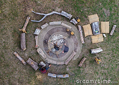 Aerial top down view of Big campfire With Circles of Logs. Bonefire for ecological Mode of life. Everyday life Cooking Stock Photo