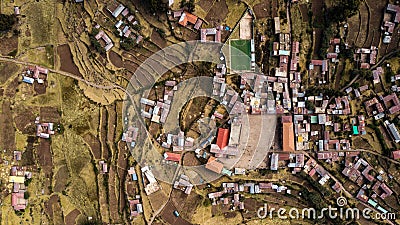 Aerial top-down view of main square at Taquile Island, visible houses, football field, terraced slopes Stock Photo