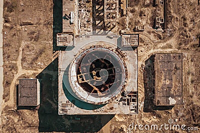 Aerial top down view of ruined Nuclear Power Plant in Crimea. Industrial construction with round tower of atomic reactor Stock Photo