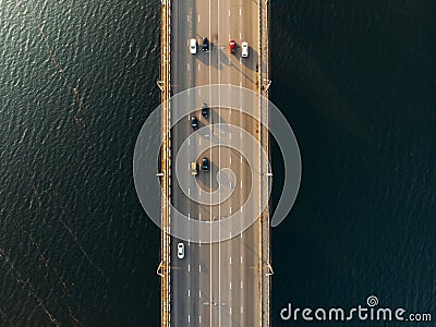 Aerial or top view of bridge with asphalt road or highway over big river with city car traffic, urban transportation Stock Photo