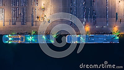 Aerial top view car carrier vessel at night, rows of new cars at night waiting to be dispatch and shipped import export new cars Stock Photo