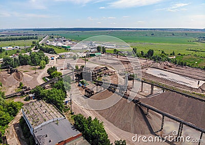Aerial top view of crushing machinery, conveying crushed granite gravel stone in quarry open pit mining. Processing plant for Stock Photo