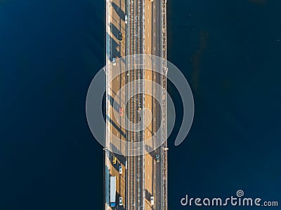 Aerial or top view from drone of concrete bridge with asphalt road or highway over big river with city car traffic Stock Photo