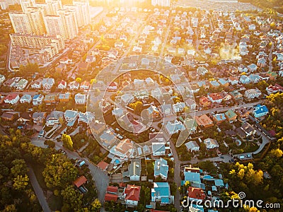 Aerial top view from flying drone above suburban neighborhood with residential houses and streets Stock Photo