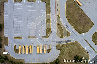 Aerial top view the yellow school buses parked near the high school Stock Photo