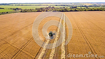 Aerial top view harvester machine working in fields Stock Photo