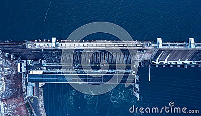 Aerial top view hydroelectric dam, water discharge through locks, blue color banner industrial concept Stock Photo