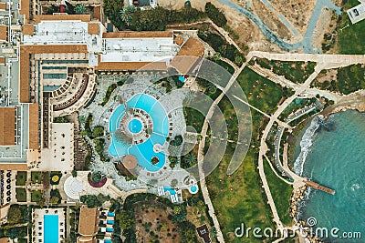 Aerial top view of little hotel with swimming pool, sunbeds and palms from above, tropical holiday resort, mediterranean Stock Photo