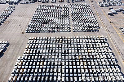 Aerial top view new cars lined up in the port for import export business logistic and transportation by ship in the open sea. New Stock Photo