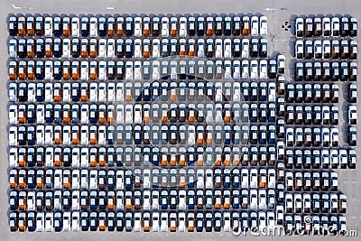 Aerial top view new cars lined up in the port for import export business logistic and transportation by ship in the open sea. New Stock Photo