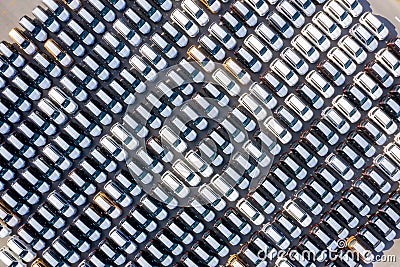 Aerial top view new cars lined up in the port for import export business logistic and transportation by ship in the open sea. New Stock Photo