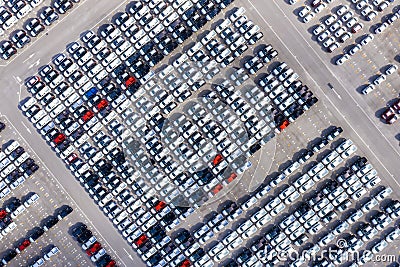 Aerial top view new cars lined up in the port for import export business logistic and transportation by ship in the open sea. New Stock Photo