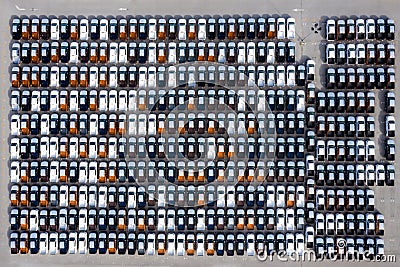 Aerial top view new cars lined up in the port for import export business logistic and transportation by ship in the open sea. New Stock Photo