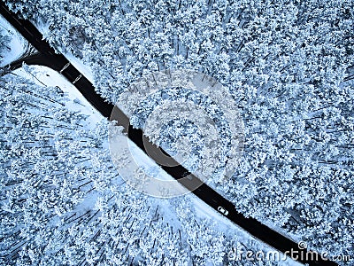 Aerial top view of road in winter forest Stock Photo