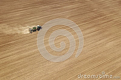Aerial Tractor sowing crops at field Stock Photo