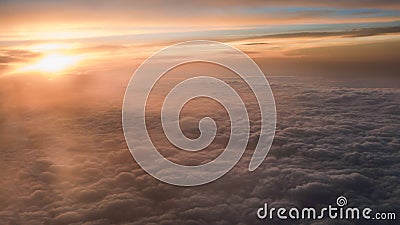 Aerial traveling. Flying at dusk or dawn. Fly through orange cloud and sun Stock Photo