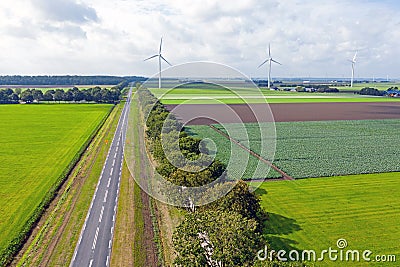 Aerial from a typical dutch landscape: straight roads, windmills and beautiful meadows in the Netherlands Stock Photo