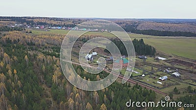 Aerial view from above over small village. Clip. Ecological place for agriculture activity and for the living located Stock Photo