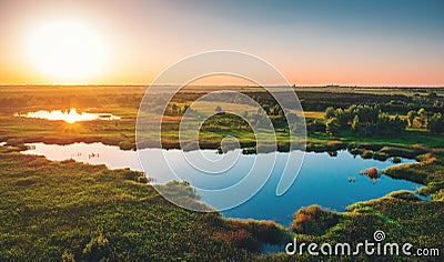 Aerial view above summer forest and lake at sunset, beautiful nature landscape panorama Stock Photo