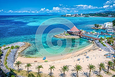 Aerial view across a resort with palm fringed beach Stock Photo